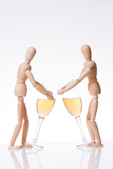 Two wooden puppet with glasses of champagne