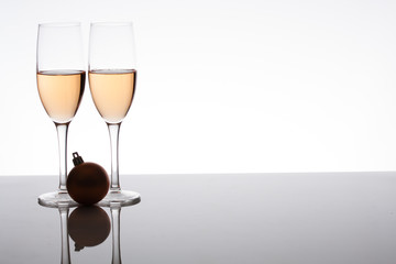 two glasses of champagne with a Christmas decoration