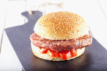 Hamburger sandwich over black stone