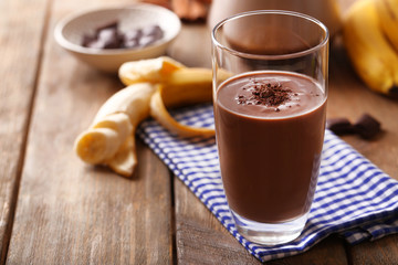 Glass of chocolate milk on table close-up