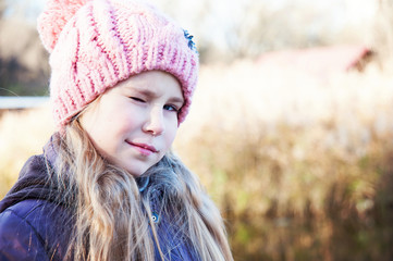 Portrait of a cheerful  cute winking girl closeup