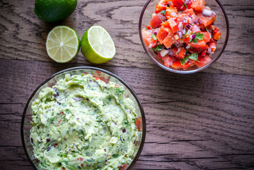 Bowls of guacamole and salsa