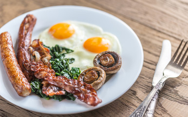 Fried eggs with bacon on the wooden table