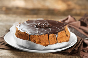 Tasty chocolate cake on wooden background