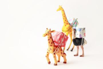 Animals-miniature ( giraffe,ostrich) carrying gift boxes.New yea