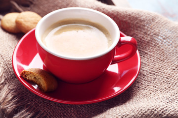 Cup of coffee on sackcloth background