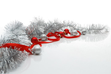 Greeting card template made of red ribbon, silver tinsel and balls with copy space, horizontal view, selective focus