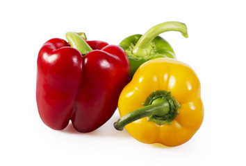 Red, green and yellow paprika on white