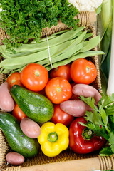 basket of seasonal vegetables on  wooden table