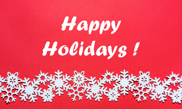 Winter holiday greeting card with snowflakes on red background