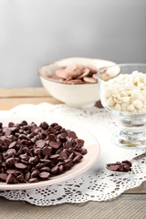 Chocolate morsels on wooden background