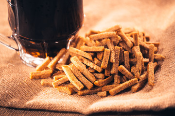  glass of fresh beer and crackers on sacking