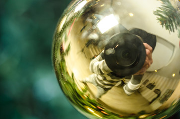 Golden Christmas decoration with reflection of photographer - Soft focus
