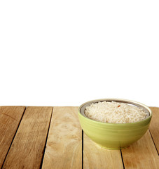 white rice is on wooden background.