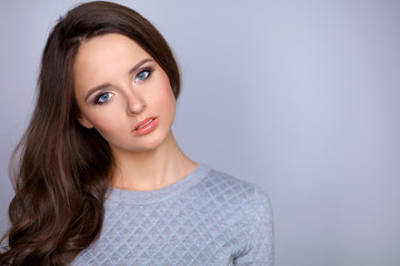 Fototapeta premium Portrait of an attractive fashionable young brunette woman