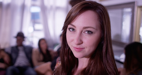 Portrait of young caucasian woman with beautiful eyes smiling at party