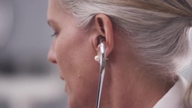 Close-up of doctor listening with stethoscope
