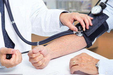Doctor measuring patient blood pressure.
