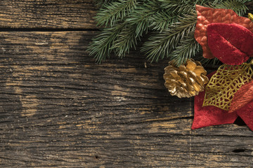 Still life of christmas ornament and tree branch on wooden board