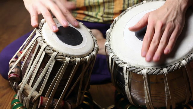 Man playing on Indian tabla drums 