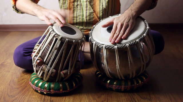 Man playing on Indian tabla drums 