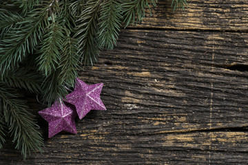 Still life of christmas ornament and tree branch on wooden board