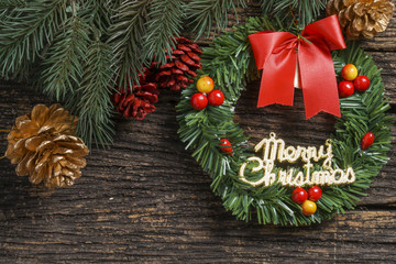 Still life of christmas ornament and tree branch on wooden board