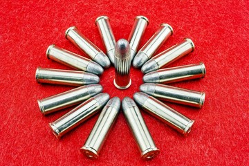 9mm. bullet for a gun on red background.