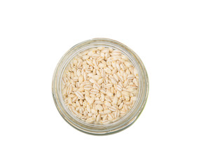 White millet grain seed in mason jar over white background