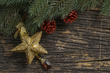 Still life of christmas ornament and tree branch on wooden board