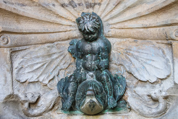 Old fountain with small boy on a dolphin on Cavour square in Rim