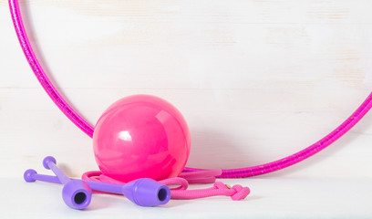 gymnastic equipment. Skipping rope, clubs for rhythmic gymnastics, hoop and ball on white background