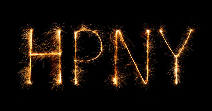 Happy New Year made of sparkles firework at night