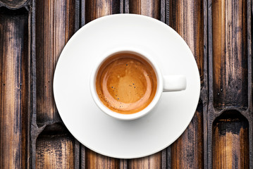 top view a cup of espresso coffee with bamboo background