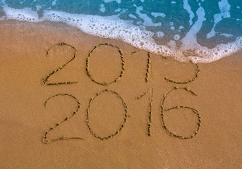 Happy New Year 2016 replace 2015 concept on the sea beach