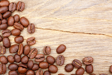 Coffee beans on wood background.