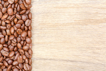 Coffee beans on wooden background.