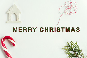 green branches and amazing christmas toys and sweets on white ba