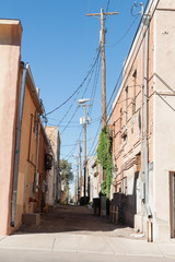 Fototapeta na wymiar Shadow across narrow alleyway Gallup New Mexico Route 66.