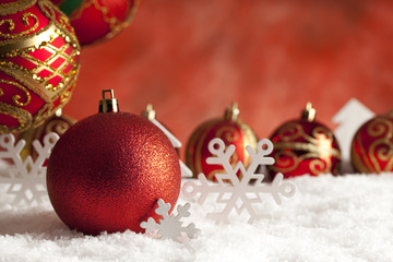 Fototapeta na wymiar Christmas baubles and decorations on snow