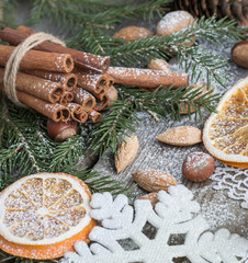 Christmas still life with almond, cinnamon on wooden table. Top view.