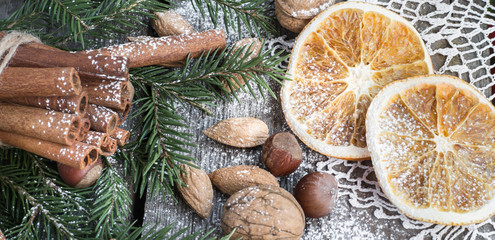 Fototapeta na wymiar Christmas still life with almond, cinnamon on wooden table. Top view.
