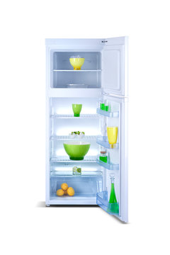 Refrigerator open with fresh food. Isolated on white.