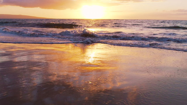 Amazing Tropical Sunset Luxury Vacation on Wet Sand Beach. Slow Motion Sunset Surf Rolls up Beach.