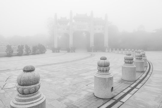 Mountain Gate at the Po Lin Monastery on Lantau Island in Hong Kong, China, at a foggy morning in black&white.