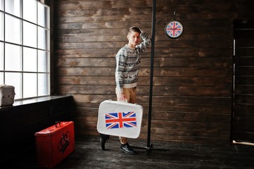 Young fashion man with the suitcase with the British flag