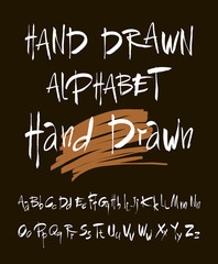 Hand drawn alphabet in retro style. ABC for your design. Letters of the alphabet written with a brush. Black background.