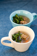 Soup with meatballs and parsley