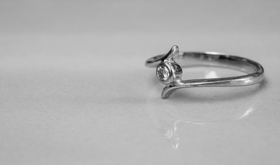 Obraz na płótnie Canvas Closeup old diamond ring on blurred marble floor background in black and white tone