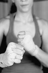 Close-up of young female boxer with tied up fists.
